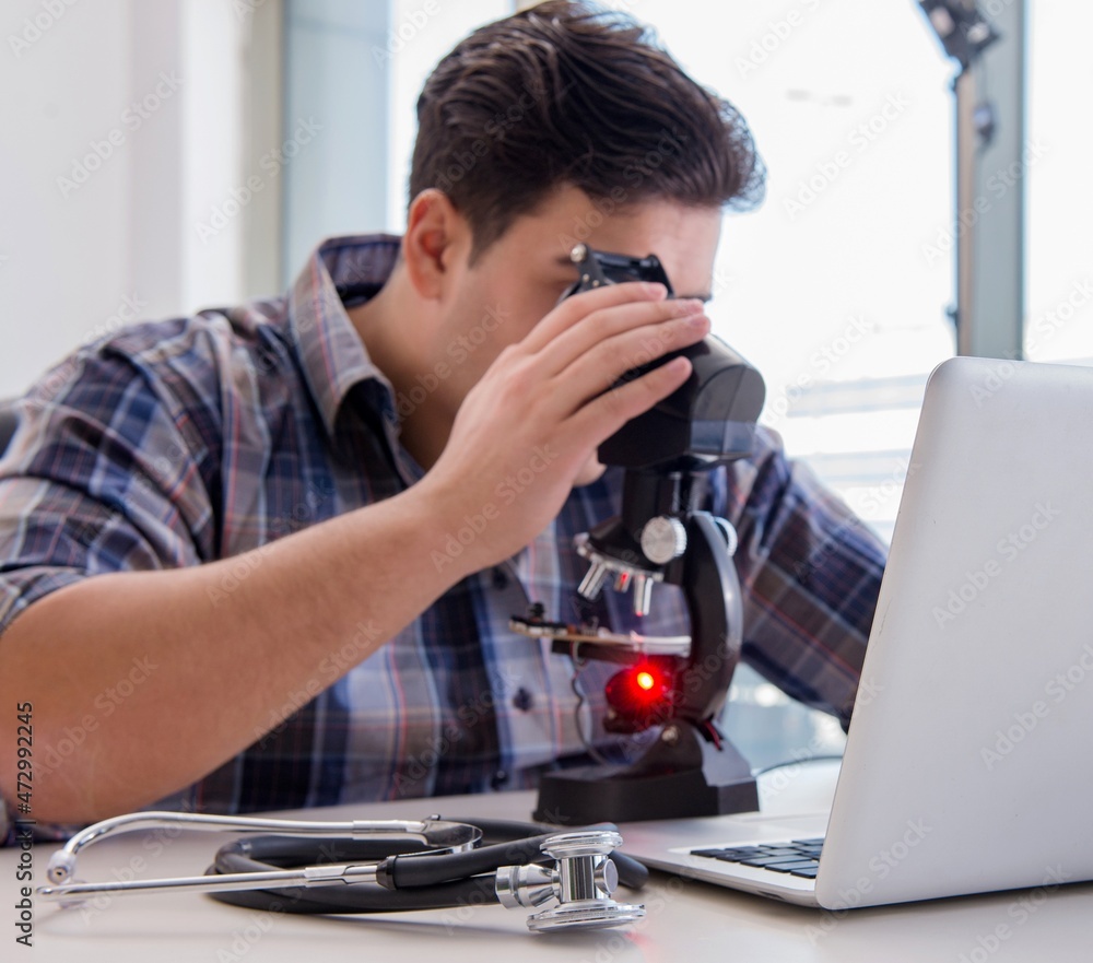 Fototapeta premium High precision engineering with man working with microscope