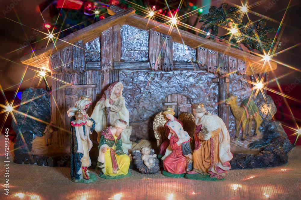 Christmas nativity scene. Hut with baby Jesus in the manger, with Mary, Joseph and the three wise men