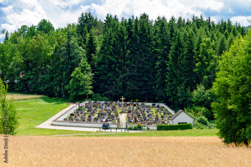  small village cemetery at the edge of a forest at summer in sunshine in the region Waldviertel (forestquarter), Austria photo