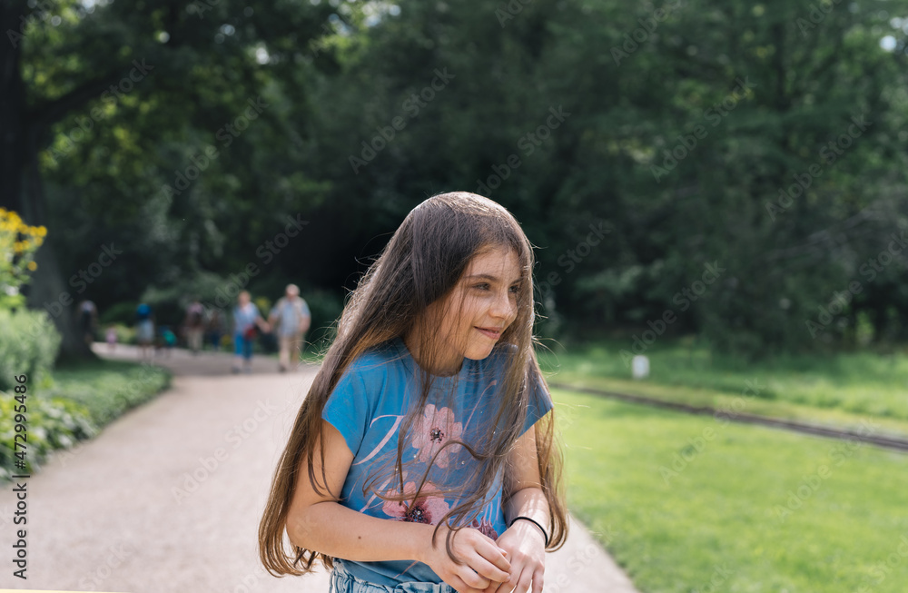 Naklejka premium Content girl having fun in park