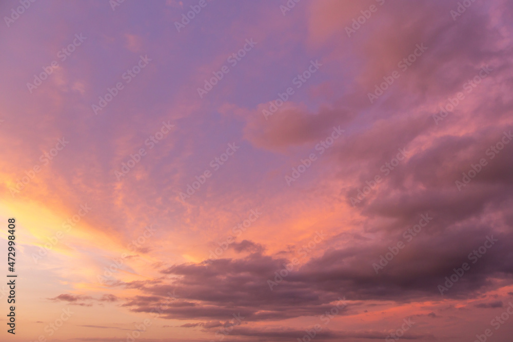 Beautiful epic sunrise, sunset storm orange pink violet blue sky with clouds in sunlight abstract background texture	