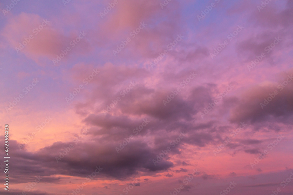 Dramatic sunrise, sunset pink violet blue sky with clouds background texture