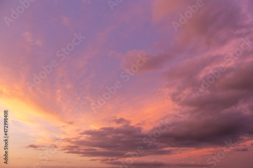 Beautiful epic sunrise, sunset storm orange pink violet blue sky with clouds in sunlight abstract background texture © Viktor Iden