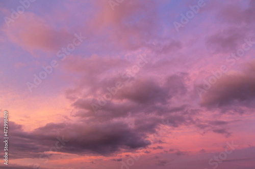 Dramatic sunrise  sunset pink violet blue sky with clouds background texture