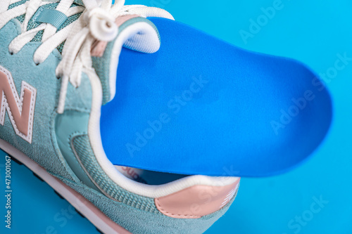 Orthopedic insoles for shoes on a colour background. Foot care photo