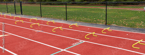 Wicket drill set up on track in two lanes with yellow mini hurdles