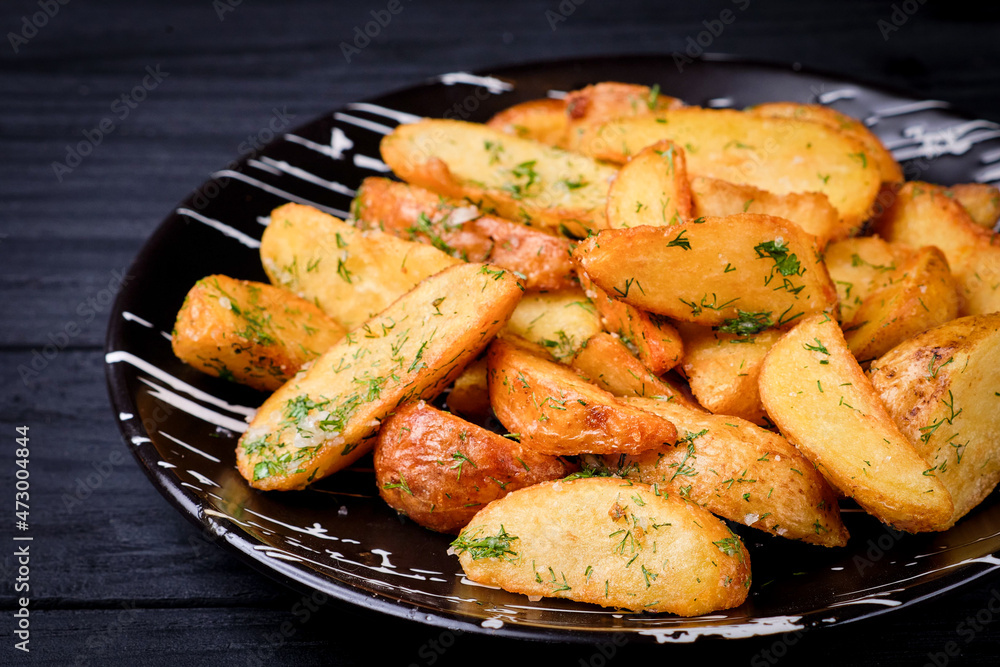 Baked Peasant potatoes served with sea salt and fresh dill. Large fried Potato pieces served on black plate on wooden background. Close up image. Homemade garnish. Rustic side dish
Baked Peasant potatoes served with sea salt and fresh dill. Large fried Potato pieces served on black plate on wooden background. Close up image. Homemade garnish. Rustic side dish