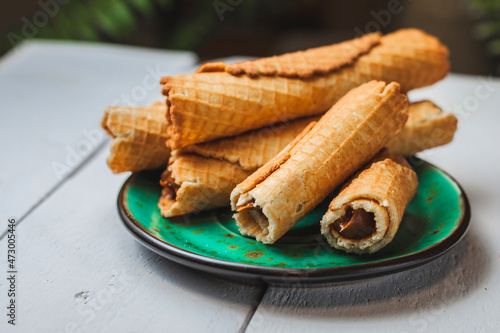 Wafer rolls with condensed milk. Thin and Crispy Waffle. Selective focus
