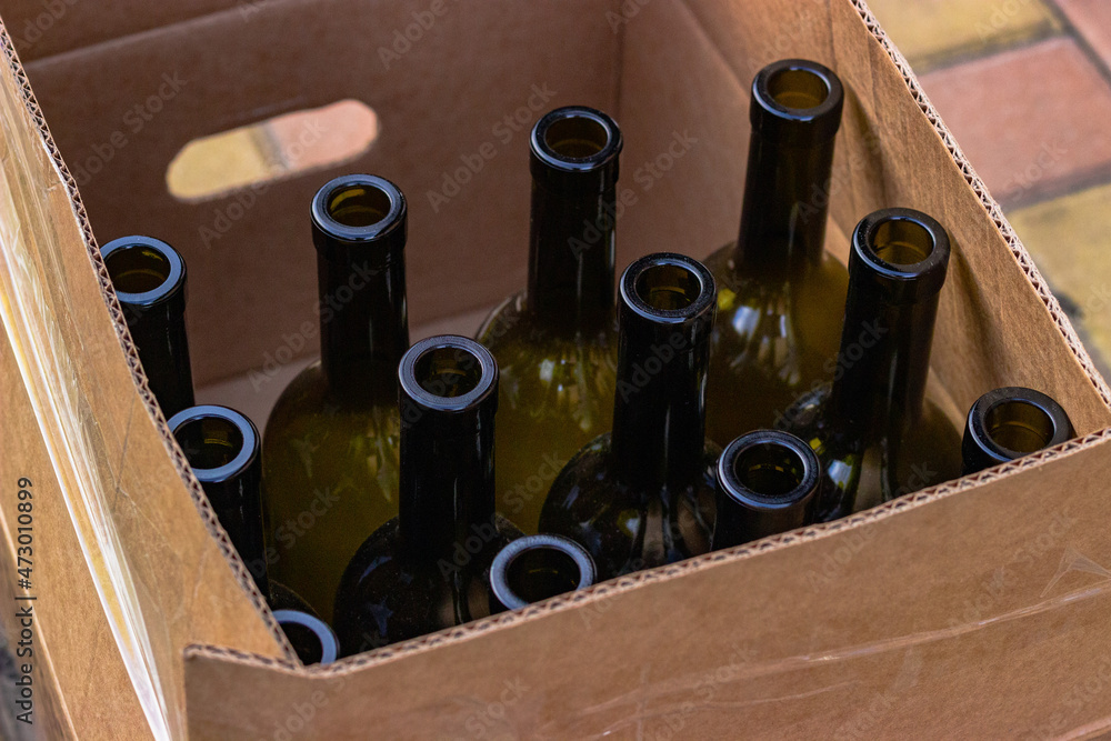 Cardboard box with empty wine bottles prepared for bottling
