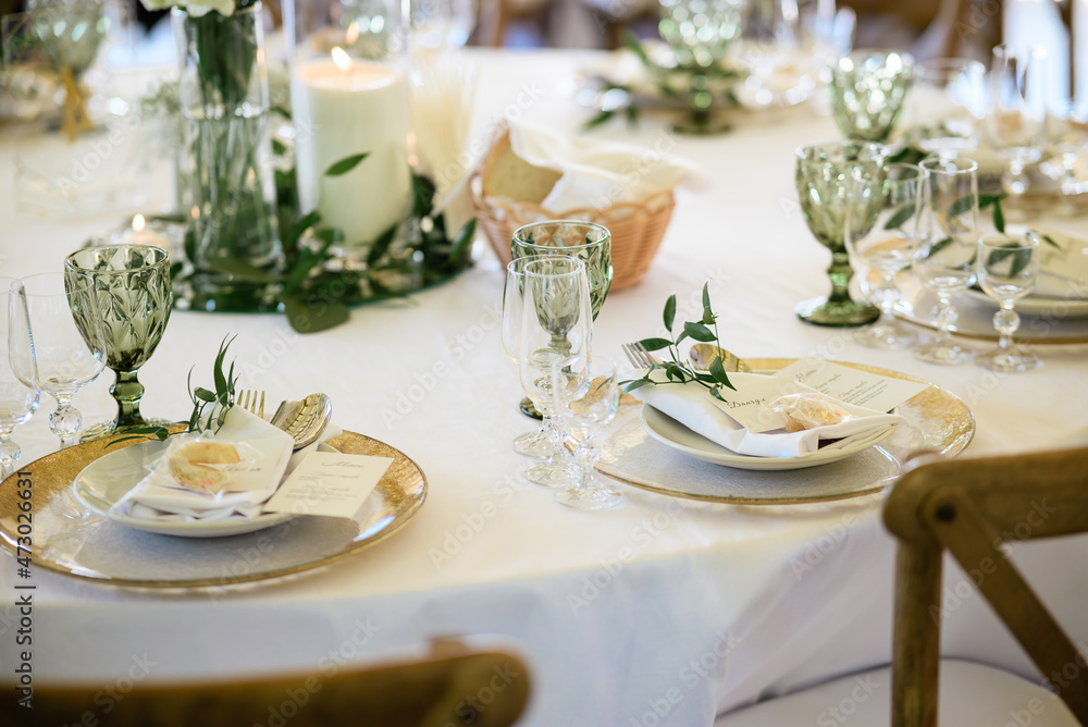 Plates of gold on a white table. Wedding d?cor