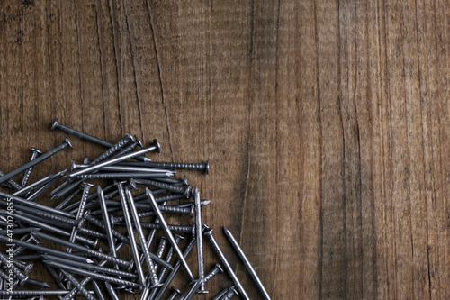 Close up of carpentry nails. Nails on a wooden background.