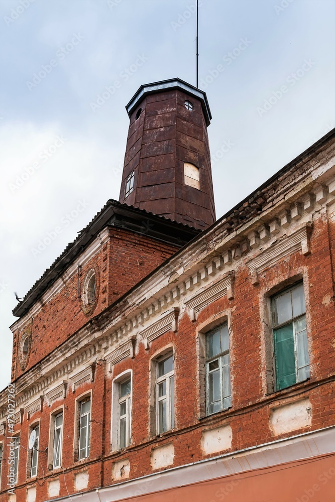 Russia, Staraya Russa, August 2021. Fire tower and part of the building facade.