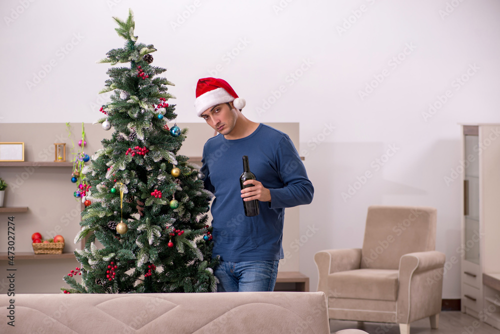 Young man celebrating Christmas alone at home Young man celebrating Christmas alone at home