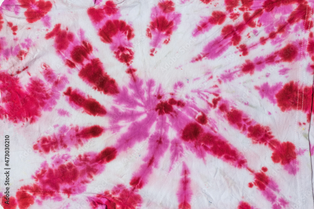 Abstract background of red and white fabric in tie dye style. Flat lay.