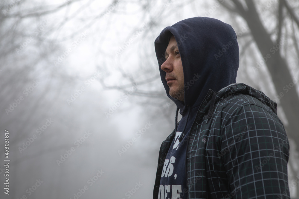 Portrain man in fog landscape. Man walking alone on scary foggy misty road. Portrain man in fog landscape. Man walking alone on scary foggy misty road.