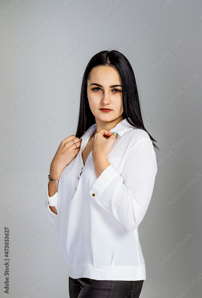 Beautiful, young girl with long black hair, in a white shirt, portrait. Beautiful, young girl with long black hair, in a white shirt, portrait.
