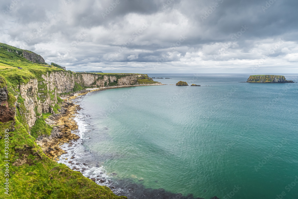 Coastline with tall limestone cliffs, Sheep Island and turquoise Atlantic Ocean, near Carrick a Rede rope bridge, Wild Atlantic Way, Northern Ireland