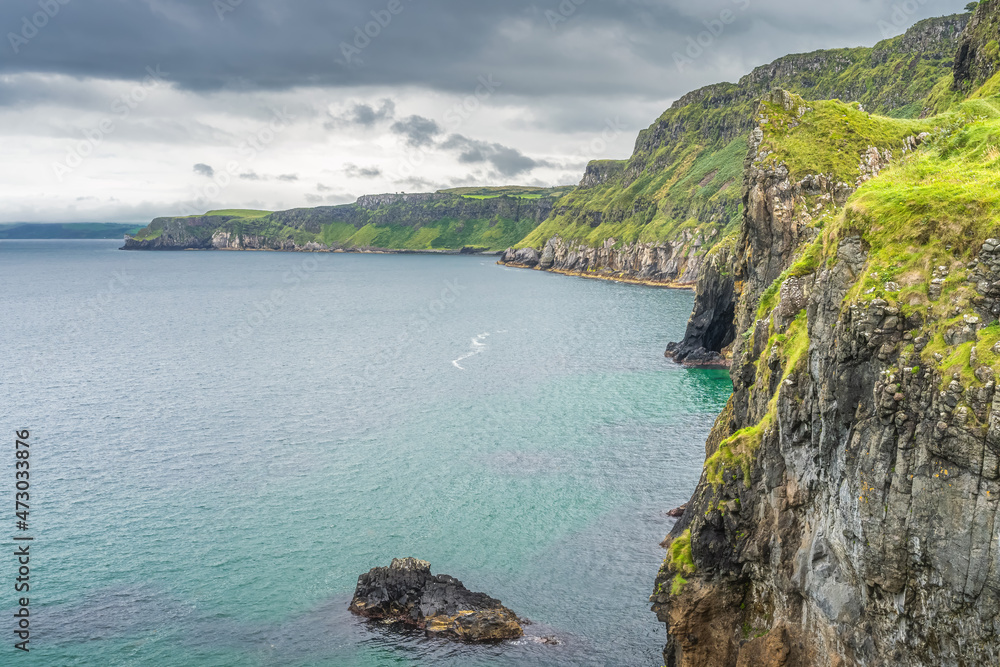 Coastline with tall limestone cliffs, Rathlin Island and turquoise Atlantic Ocean near Carrick a Rede rope bridge, Wild Atlantic Way, Northern Ireland