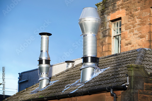 Flue chimney fixed to building exterior wall stainless steel from exhaust boiler plant room