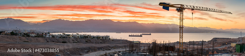 Panoramic aerial view on construction site and the gulf of Aqaba at dawn