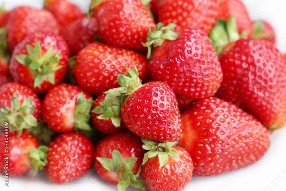 Fresh red strawberries with leaves. Pile of ripe strawberry for background Fresh red strawberries with leaves. Pile of ripe strawberry for background
