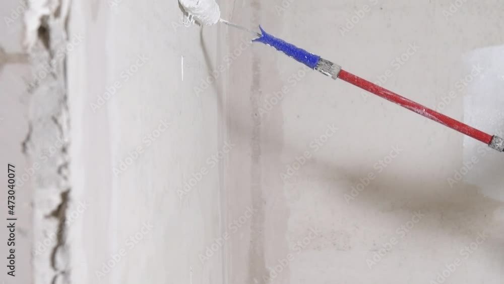 painting the walls during the repair of the room with a roller, white paint. High quality FullHD footage painting the walls during the repair of the room with a roller, white paint. High quality FullHD footage