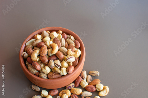 mixed nuts in bowl. (almonds, pistachios, hazelnuts, cashews, peanuts)