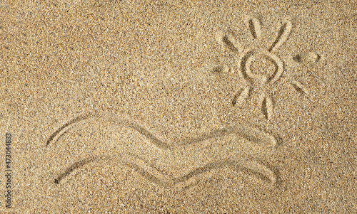 Drawing of the sun and sea waves on the sand. View from above
