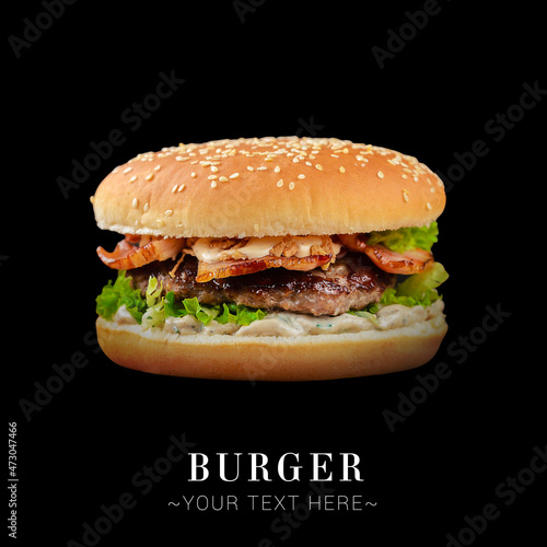 Savory pork burger with grilled bacon  melted cheese  lettuce  creamy sauce isolated on black background. Text space web banner 