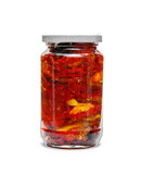 Jar with sun-dried tomatoes in olive oil isolated on white.