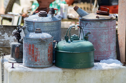 old gas cans for sale at an outdoor market