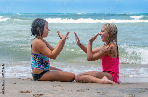 Two sisters are Playing games on the beach