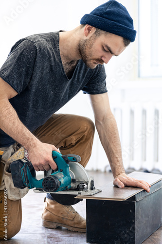 Circular Saw, carpenter using a circular saw for wood.