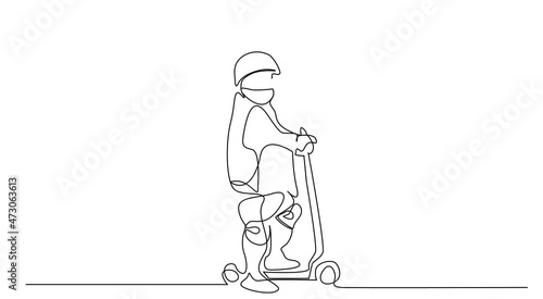 Little boy wearing mask during quarantine riding scooter outside. Young boy driving new modern urban practical transport vehicles.