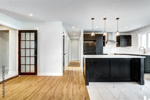 Typical budget Canadian single family house, renovated with some luxury elements in design partially furnished with kitchen, rooms, bedrooms, appliances, finished basement, laundry, backyard and patio