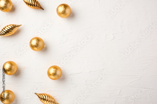 Christmas gold bauble ball decoration on white pastel table background