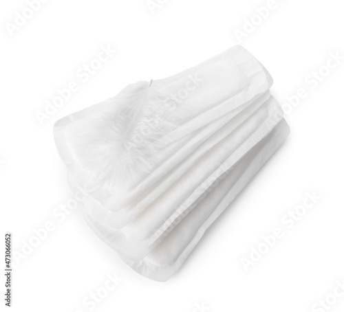 Menstrual pads and feather on white background