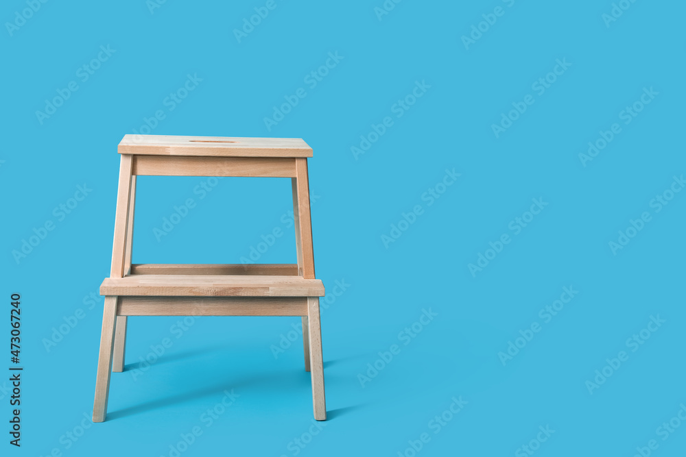 Wooden step stool on blue background Wooden step stool on blue background