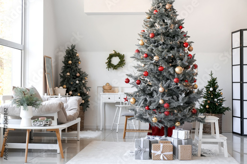 Interior of living room with Christmas trees and gifts