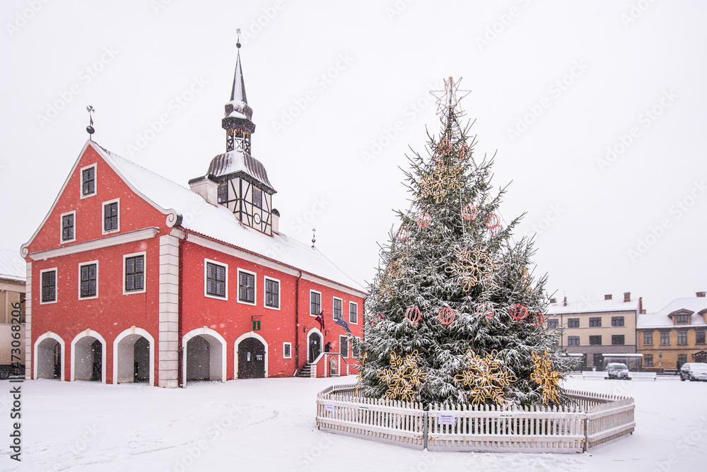 Bauska Town Hall and decorated Christmas tree on a snowy winter day, Latvia