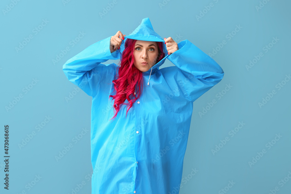 Funny woman with bright hair wearing raincoat on color background Funny woman with bright hair wearing raincoat on color background