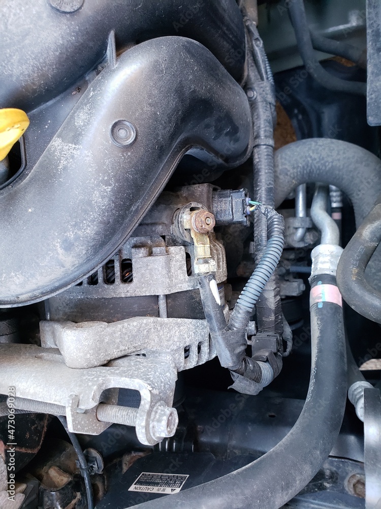 Old Alternator seen inside an engine of a Toyota Corolla Stock Photo