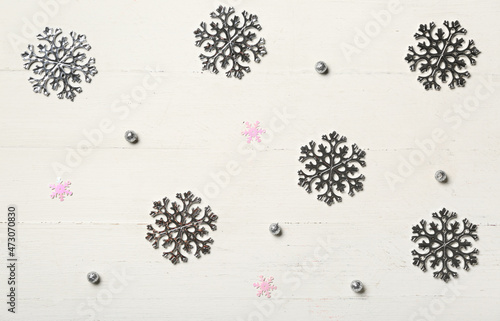 Beautiful snowflakes on light wooden background