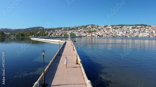 Woman walking on De Bosset Bridge in Argostoli city on Kefalonia island photo
