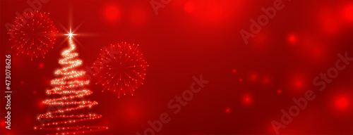 sparkling christmas tree on red bokeh shiny background