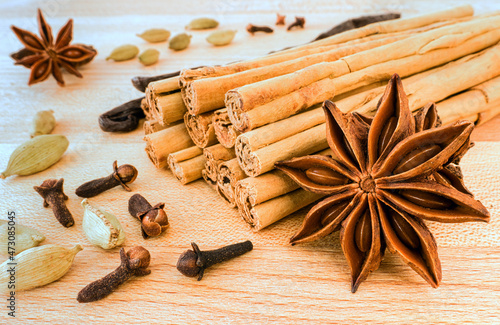 Star Anise, Cardamom, Cloves, Alba Ceylon Cinnamon Sticks and Vanille Beans on Wood