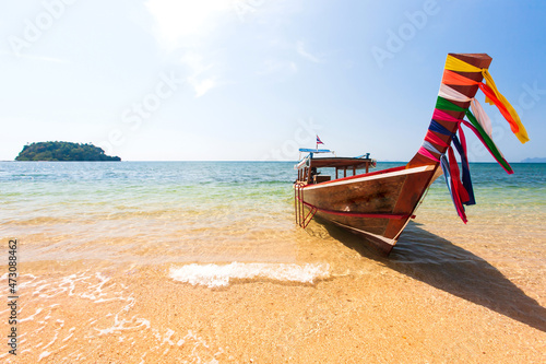 A traditional wooden boat on a beach in summer. © Tanes