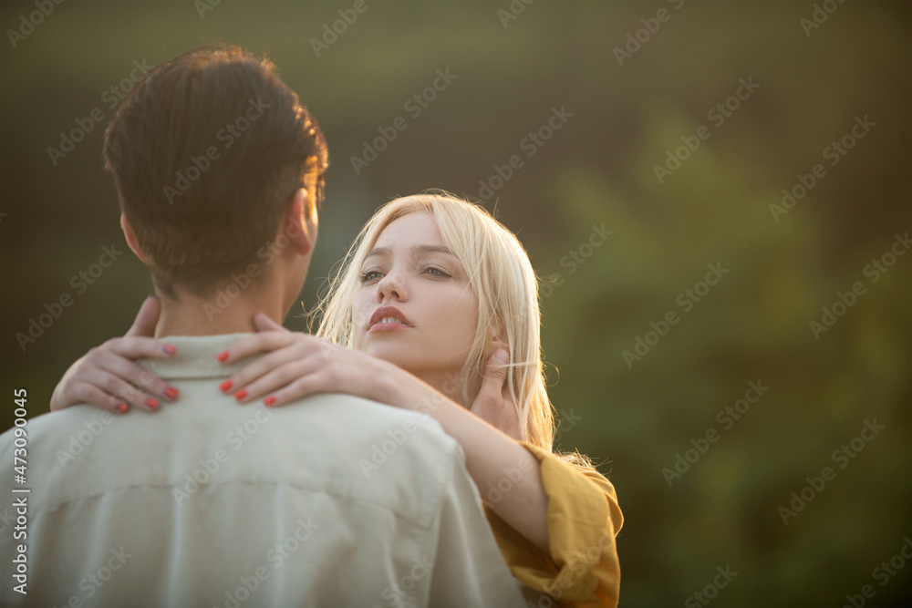 Young lovers hugging and embracing. Couple lovers hugging and kissing at sunset. Couple in love tenderness and affection. Young lovers hugging and embracing. Couple lovers hugging and kissing at sunset. Couple in love tenderness and affection.