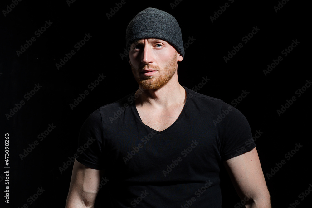 Confident attractive man with serious face on black. Confident attractive man with serious face on black.