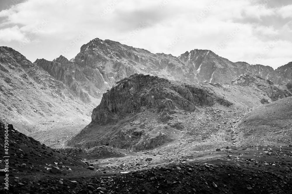 Obraz premium Beautiful dramatic monochrome landscape: mountains, hills and cloudy sky. High-contrast image 